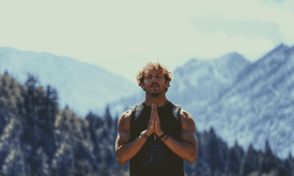 man, meditating in the mountains