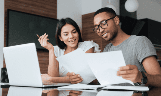 couple happily working on finances together