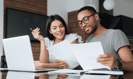 couple happily working on finances together
